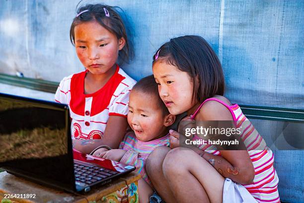curious eyes around a laptop — orkhon valley, mongolia - central asia stock pictures, royalty-free photos & images