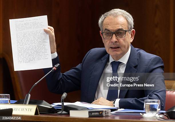 Former Prime Minister Jose Luis Rodriguez Zapatero holds a piece of paper with a message from Hugo 'El Pollo' Carvajal during his appearance before...