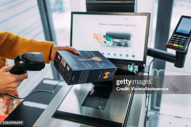 woman using self service checkout. - automatic payment stock pictures, royalty-free photos & images