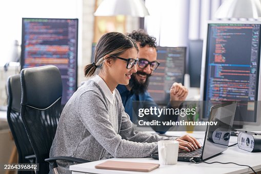 Software engineers collaborating on new program coding development Software engineers collaborating on new program coding development