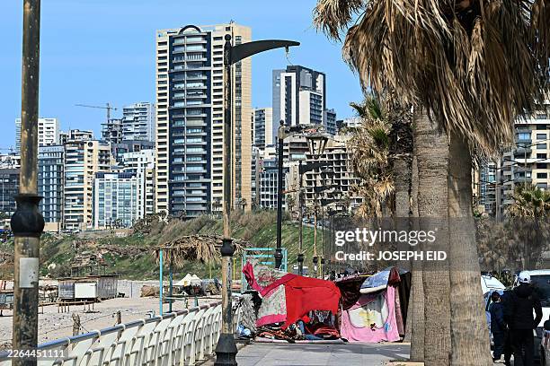 Makeshift shelters used by residents who fled Israeli airstrikes in Beirut's southern suburbs are seen along the corniche waterfront in the Lebanese...