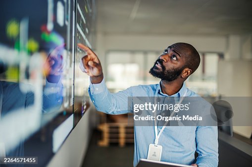 It expert analyzing digital data on interactive screen It expert analyzing digital data on interactive screen