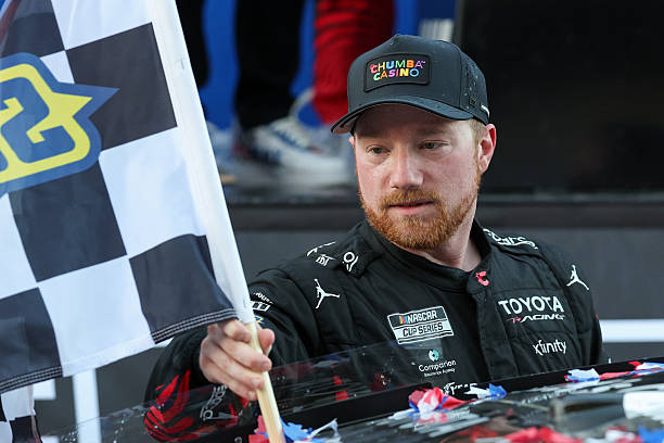 Tyler Reddick places the checkered flag into his back windshield after winning the NASCAR Cup Series DuraMAX Texas Grand Prix on March 1 at the...
