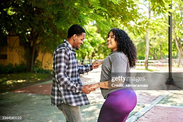 young santo domingo woman teaching dance moves to tourist - bachata stock pictures, royalty-free photos & images