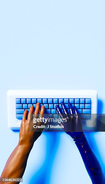 human and robot arms working on computer keyboard task - braço humano imagens e fotografias de stock