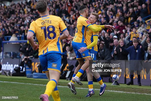 Mansfield Town's Welsh striker Will Evans celebrates with teammates after scoring their first goal during the English FA Cup fifth round football...