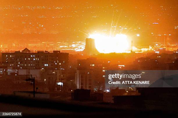 An explosion erupts following strikes near Azadi Tower close to Mehrabad International Airport in Tehran on March 7, 2026. The United States and...