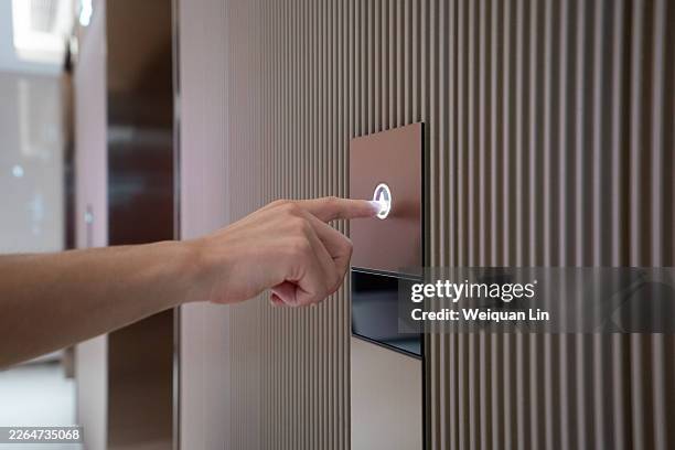 one hand presses the elevator button - hand elevator button stock pictures, royalty-free photos & images