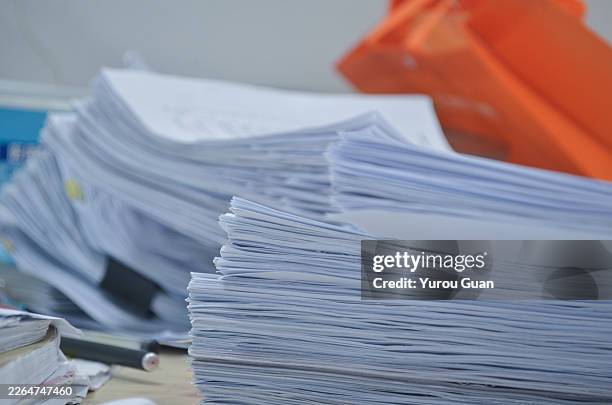 overflowing desk with pending files.workload pressure concept.a cluttered office desk completely covered with towering stacks of untouched documents and pending files, visually representing overwhelming workload and administrative backlog. - paper mess stock pictures, royalty-free photos & images