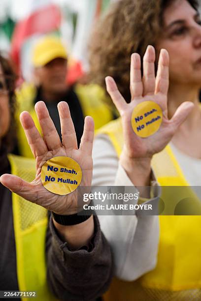 Protesters show their hands with the slogan NO SHAH, NO MOLLAH during a rally calling for a pluralist and secular republic in Iran organized by...