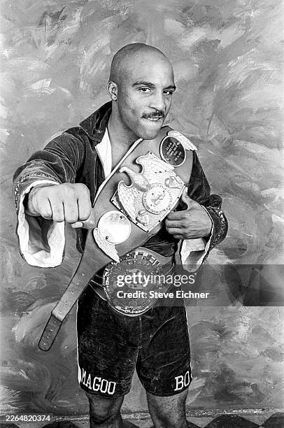 Portrait of American professional boxer Buddy McGirt , wearing both his International Boxing Federation & World Boxing Council title belts, as he...