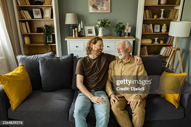happy men laughing enjoying time together at home - grandpa son stock pictures, royalty-free photos & images