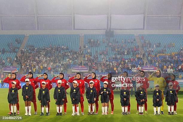 Iranian players salute during the national anthem before the AFC Women's Asian Cup Australia 2026 football match between Iran and Philippines in Gold...