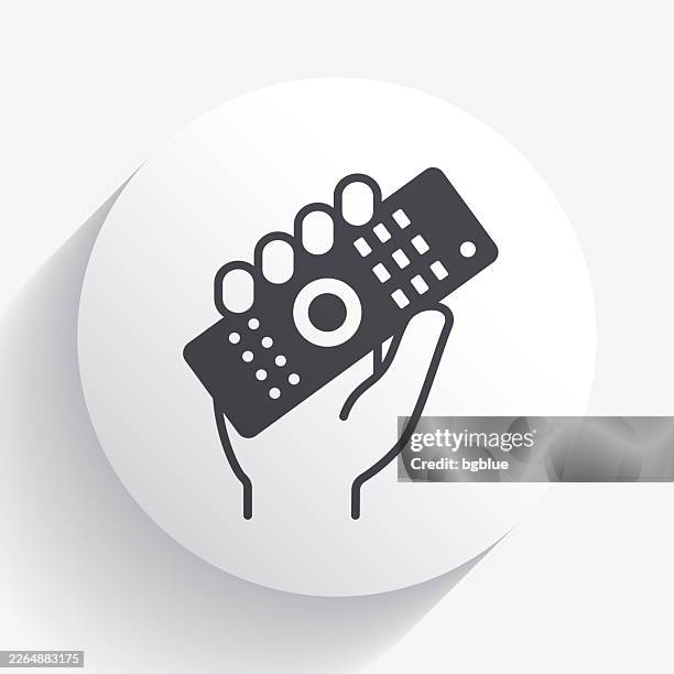 hand holding up remote control. icon on circle button with long shadow - remote controlled stock illustrations