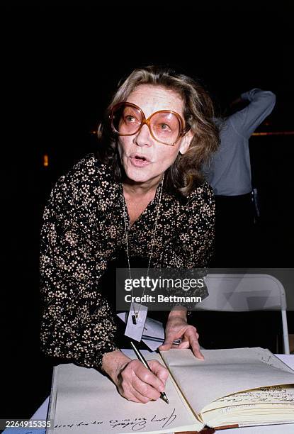 American actress Lauren Bacall signing a guest book during rehearsals for 'Night of 100 Stars', a gala benefit for the Actors' Fund of America, at...