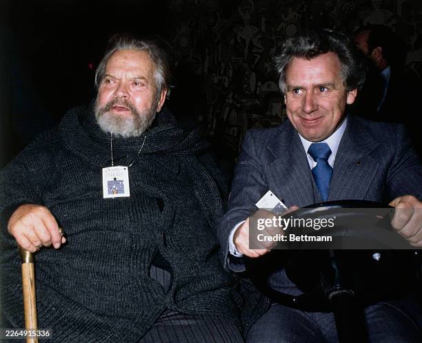 American actor Orson Welles being driven in a golf cart to rehearsals for 'Night of 100 Stars', a gala benefit for the Actors' Fund of America, at...