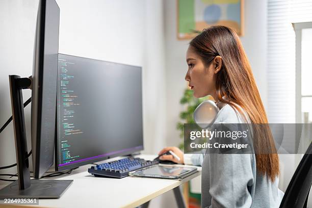 female data scientist coding ai solution in modern home office. - java code stock pictures, royalty-free photos & images