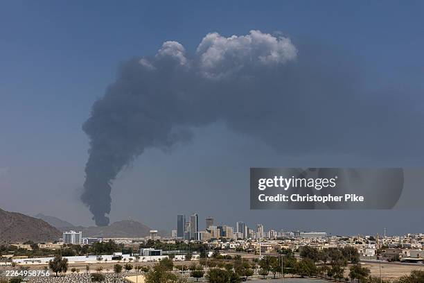 Smoke rises after an explosion in the industrial zone, caused by debris after interception of a drone by air defence, according to the Fujairah media...