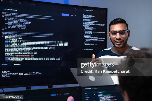 Indian Programmer, Project Team Leader Presenting a Work Update, Discussing Project, Explaining Detail Collaboration in Tech Office. Indian Programmer, Project Team Leader Presenting a Work Update, Discussing Project, Explaining Detail Collaboration in Tech Office.