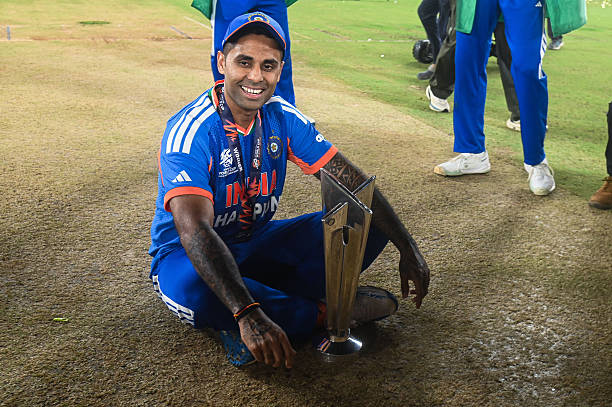 India's captain Suryakumar Yadav poses with the trophy as India wins the final match of the ICC Men's T20 World Cup against New Zealand at Narendra...