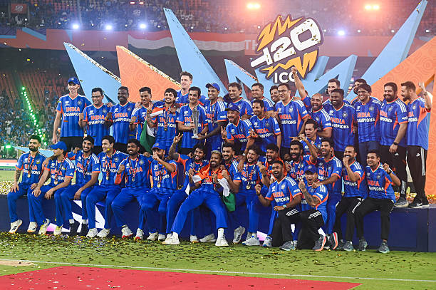 The Indian Cricket Team poses with the trophy as they win the final match of the ICC Men's T20 World Cup against New Zealand at Narendra Modi Stadium...