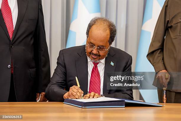 Somali President Hassan Sheikh Mohamud signs the countryâs new constitution during a ceremony in Mogadishu after 222 members of parliament and senate...