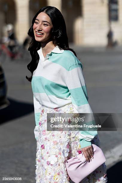 Ameera Khan wears a white and mint green striped polo sweater, a floral 3d fabrics round skirt and a pink leather bag outside Dior show during Day...