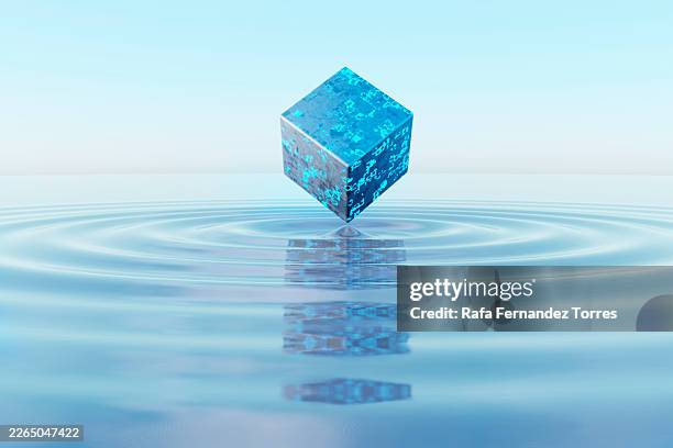 floating digital cube over water with glowing blue data - código binário imagens e fotografias de stock