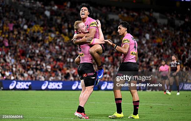 Thomas Jenkins of the Panthers is congratulated by team mates after scoring a try during the round one NRL match between Brisbane Broncos and Penrith...