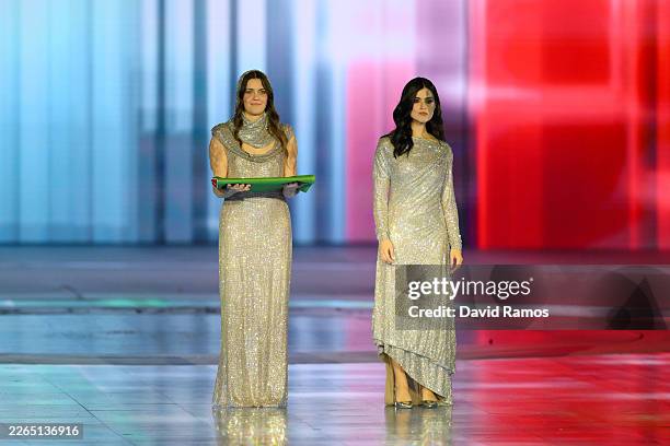 Veronica Yoko Plebani, Athlete of Team Italy holds the flag of Italy beside Model and Influencer Carlotta Bertotti during the Milano Cortina 2026...