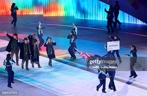 Athletes of Team Australia wave as they walk through the stadium during the Milano Cortina 2026 Winter Paralympic Games opening ceremony at Arena di...