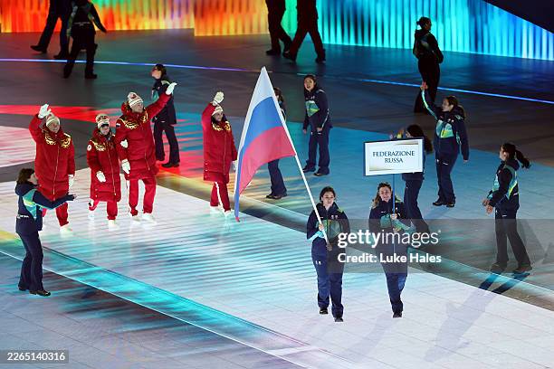 Volunteer Flagbearers of Team Russia walk through the stadium with athletes of Team Russia during the Milano Cortina 2026 Winter Paralympic Games...