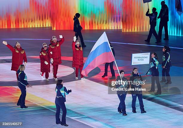Volunteer Flagbearers of Team Russia walk through the stadium with athletes of Team Russia during the Milano Cortina 2026 Winter Paralympic Games...