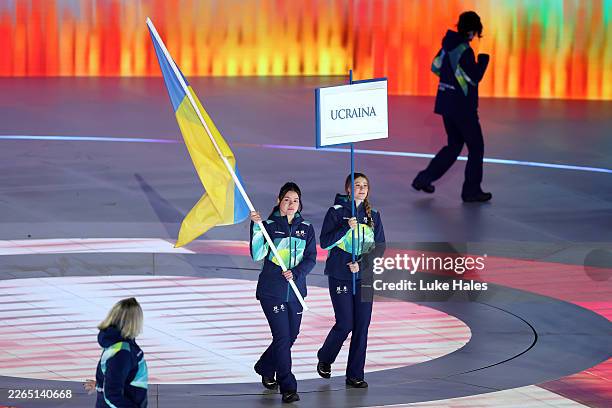 Volunteer Flagbearers of Team Ukraine walk through the stadium during the Milano Cortina 2026 Winter Paralympic Games opening ceremony at Arena di...