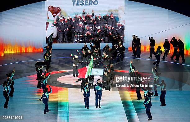 Volunteer Flagbearers of Team Italy walk through the stadium with athletes of Team Italy during the Milano Cortina 2026 Winter Paralympic Games...