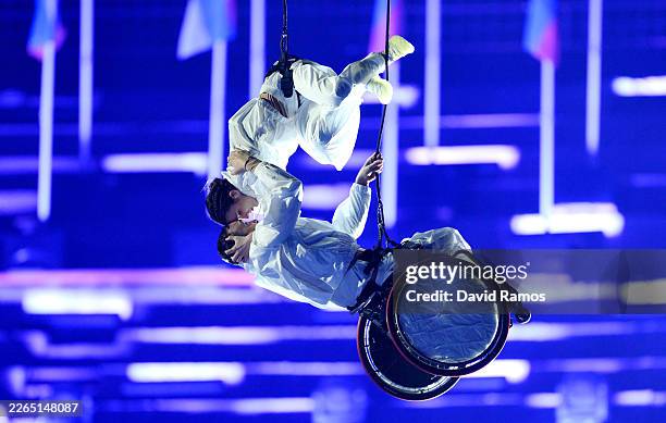 Aerialists from Il Posto Vertical Dance Company perform during the Milano Cortina 2026 Winter Paralympic Games opening ceremony at Arena di Verona on...