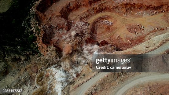 Slow Motion Massive Dynamite Explosion at Open-Pit Mine – Large Controlled Blast During Mineral Exploration and Industrial Mining Operation Slow Motion Massive Dynamite Explosion at Open-Pit Mine – Large Controlled Blast During Mineral Exploration and Industrial Mining Operation