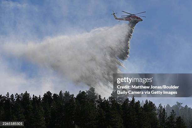 The Division of Fire Prevention and Control FIREHAWK helicopter drops water on a fire near Chautauqua in Boulder on Saturday, Feb. 28, 2026. More...