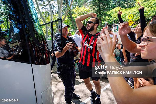 Members of the Iranian community in Australia block the path of a departing bus transporting members of the Iranian Women's Asia Cup football team to...