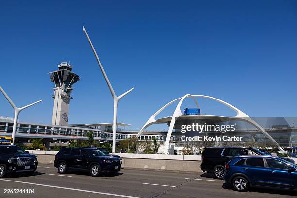 People drive at Los Angeles International Airport with the air traffic control tower in the background on March 7, 2026 in Los Angeles, California.