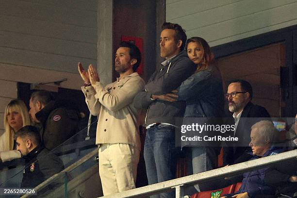 American Actor and Screenwriter Rob McElhenney applauds as Ryan Reynolds, Actor and Co-Owner of Wrexham, is embraced by his wife and Actress Blake...