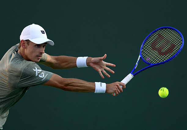 Alex De Minaur of Australia plays a backhand in a match against Sebastian Korda of the United States during Day 4 of the BNP Paribas Open at Indian...