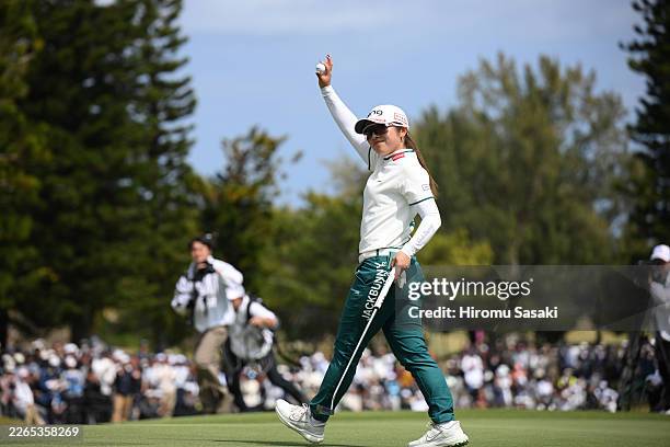 Shuri Sakuma of Japan acknowledges the gallery after winning the tournament on the 18th green during the final round of Daikin Orchid Ladies Golf...