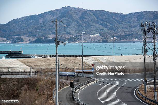Buddhist monk walks along the coastline in Minamisanriku, Miyagi Prefecture, on March 11 the 15th anniversary of the Great East Japan Earthquake and...