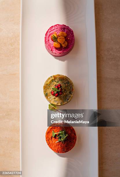 gourmet appetizer meze dip with beetroot, eggplant and peppers servied in middle eastern restaurant - middle eastern food stock pictures, royalty-free photos & images
