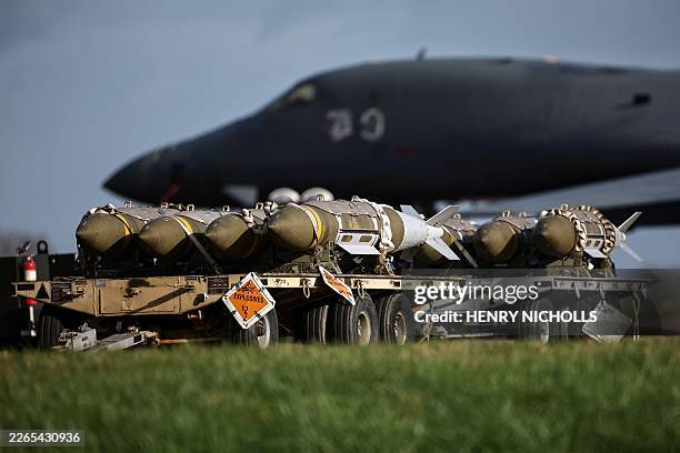 Joint Direct Attack Munitions sit next to a US Air Force B-1 Lancer bomber on the tarmac at RAF Fairford in south-west England on March 11, 2026....