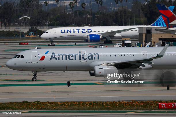 American Airlines and United Airlines airplanes taxi at Los Angeles International Airport on March 7, 2026 in Los Angeles, California.