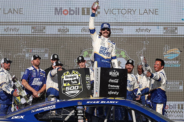 Ryan Blaney, driver of the Dent Wizard Ford, celebrates in victory lane after winning the NASCAR Cup Series Straight Talk Wireless 500 at Phoenix...