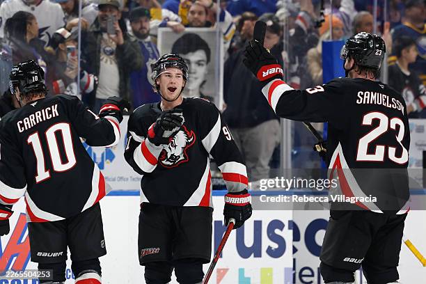 Josh Doan of the Buffalo Sabres celebrates the win with Mattias Samuelsson of the Buffalo Sabres following the game against the Tampa Bay Lightning...