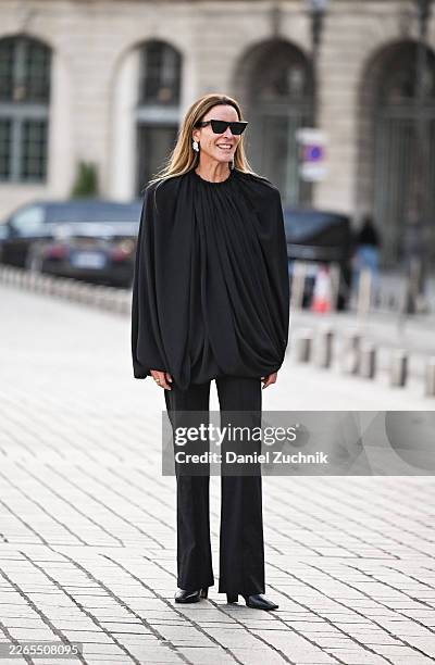 Guest is seen wearing a black blouse, black pants, black heels and black sunglasses outside the Magda Butrym show during Day Seven of Paris Fashion...